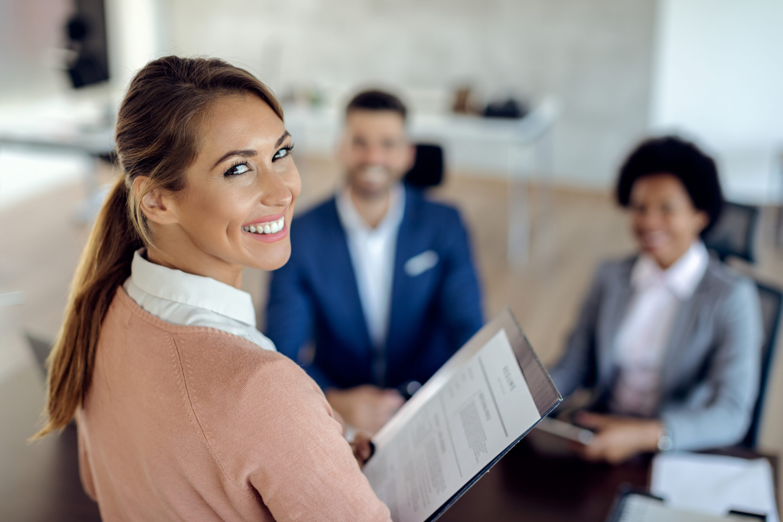 Happy woman applying for job in the office and looking at the camera.